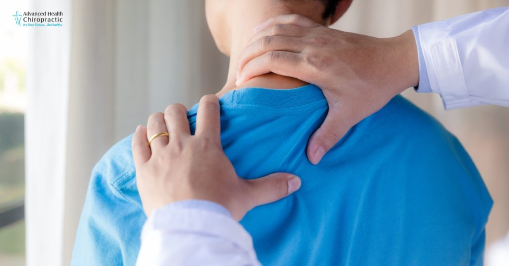 Chiropractor performing shoulder adjustment