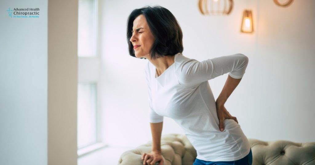 Chiropractor performing spinal adjustment for natural back pain relief in Michigan.