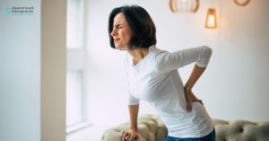 Chiropractor performing spinal adjustment for natural back pain relief in Michigan.